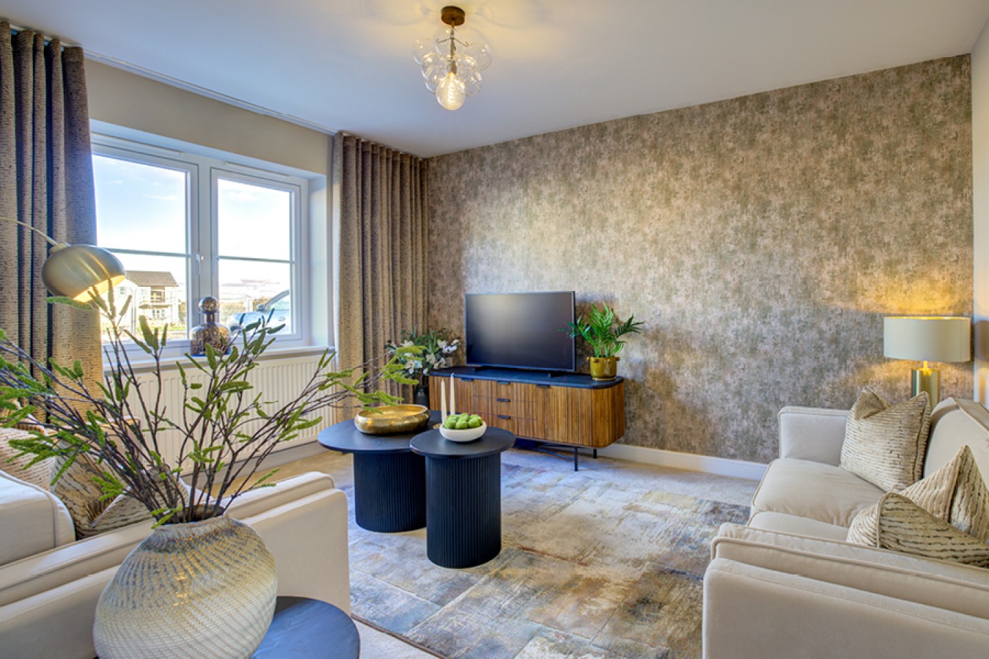 Contemporary lounge with neutral colours and statement black and wooden TV stand